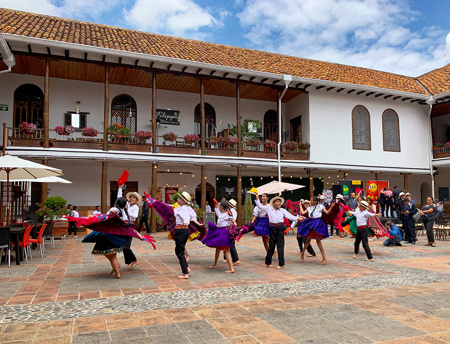 cuenca, children dancing, plaza, buildings, clouds, sky, things to do in Cuenca Ecuador, what to do in Cuenca Ecuador