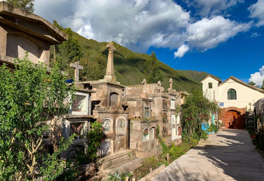 Urubamba cemetery, church, tombstones, flowers, path, clouds, sky, mountains, trees