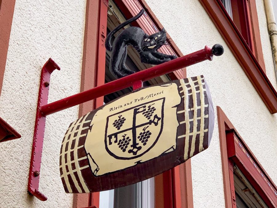 Mosel River Valley, black cat brass sign, building, Zell, wine cask