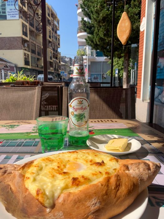Adjarian Khachapuri, tarragon lemonade, Acharuli Khachapuri Center, buildings, table, butter, plate, cup, where to eat in Batumi