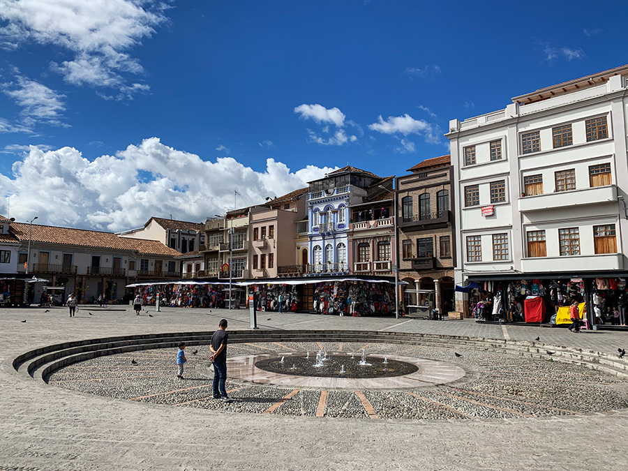 Plaza de san Francisco, fountain, colonial buildings, plaza cuenca,  man, sky, clouds, things to do in Cuenca Ecuador