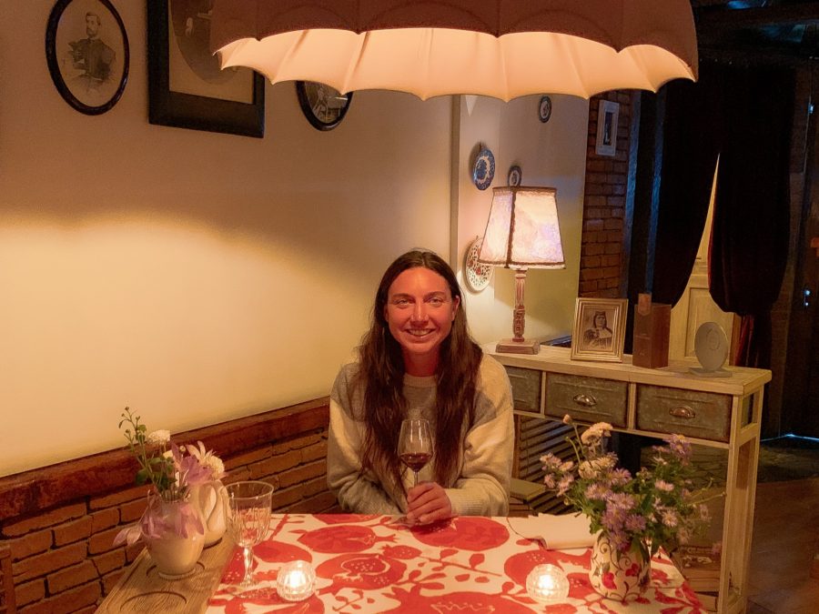me at Barbarestan, best places to eat in Tbilisi, woman, smiling, flowers, restaurant