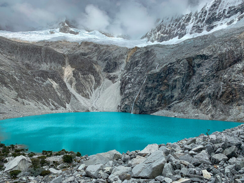 laguna 69, Lake 69, Huaraz, North Peru Itinerary, alpine lake, stones, mountains, glacier, sky, clouds, snow, waterfall