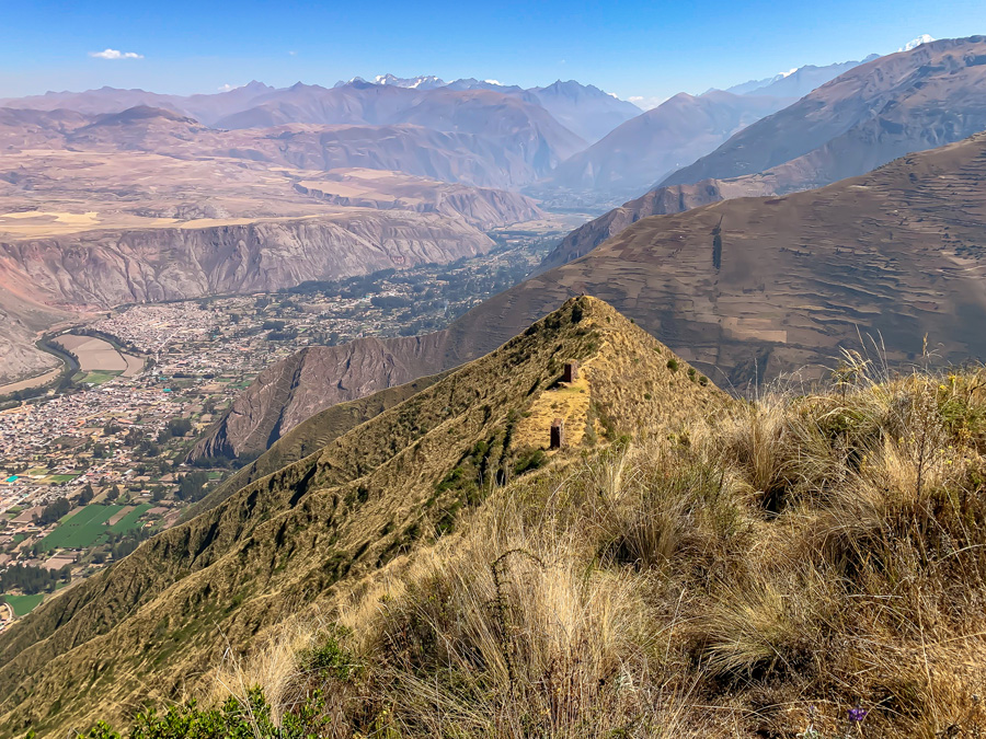 Saywa, Saywa Archaeological Park, grass, rock pillars, mountains, Urubamba, Sacred Valley, clouds, haze, sky, Sacred Valley hikes, things to do in Urubamba, Peru's Sacred Valley, hiking in Sacred Valley Peru