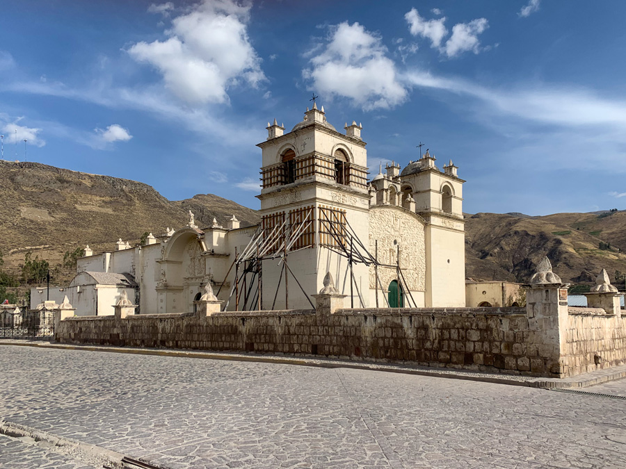 Yanque Plaza de Armas, church, white church, mountains, clouds, sky, South American villages in Peru