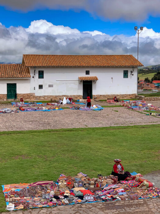 Boleto Turístico Cusco, Cusco Tourist Ticket Circuit III, Chinchero Archaeological Park, building, clouds, sky, grass, Sacred Valley, woman selling handicrafts
