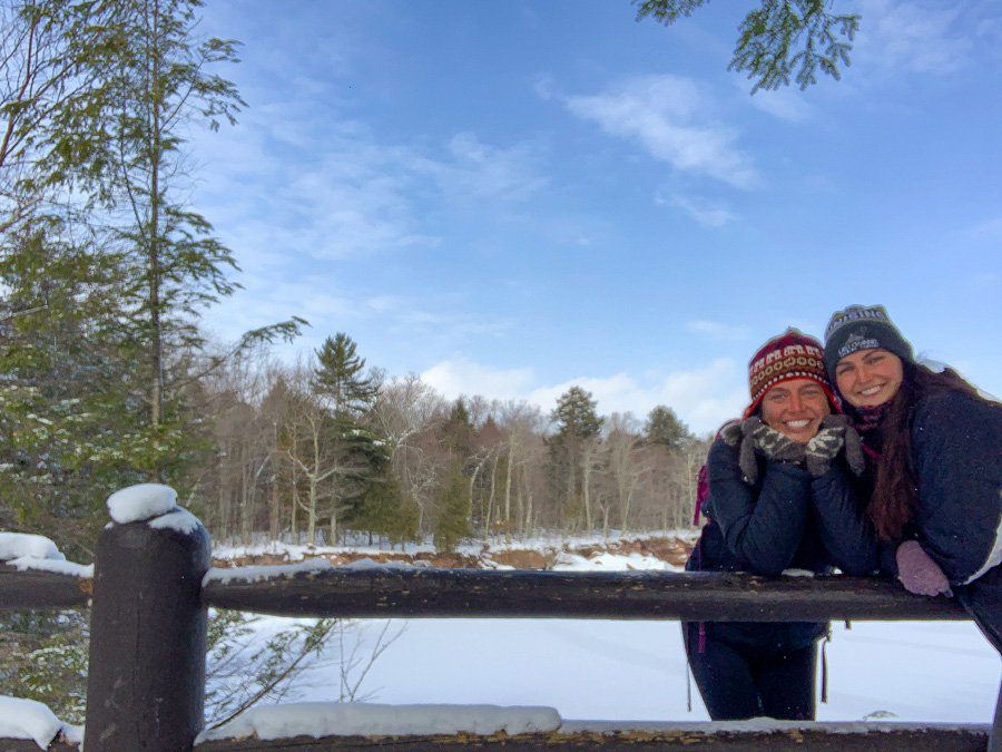 women smiling, Big Bay State Park Wisconsin, trees, snow, fence, sky, clouds