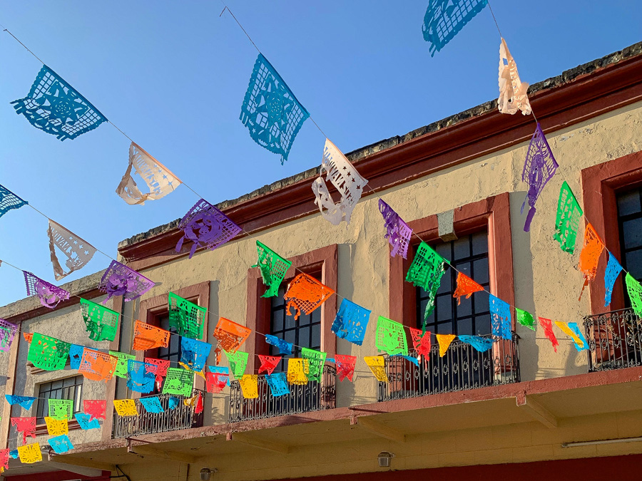 papel picado, bright and colorful paper flags in Mexico, sky, building, Oaxaca, Oaxaca de Juárez