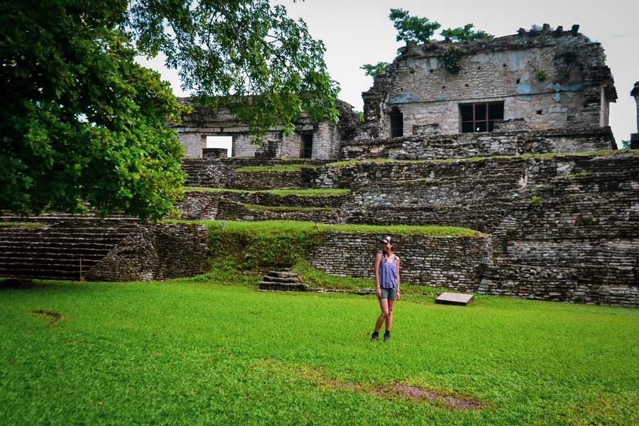 Palenque ruins, things to see in Palenque, Zona Arqueológica Palenque, Maya ruins, Mayan ruins in Chiapas, grass, trees, Chiapas highlights, woman, long day trips from San Cristobal de las Casas