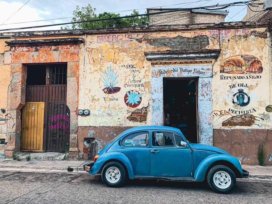a bug Volkswagon sits in front of a unique store in Oaxaca city