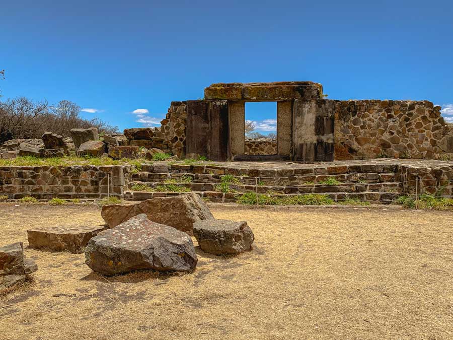 Monte Alban, Oaxaca ruins, stones, grass, sky, clouds, trees, things to do in Oaxaca, best Oaxaca day trips