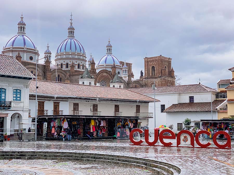 San Francisco Plaza cuenca, Cuenca Catherdral, plaza in cuenca ecuador with signboard, artisan stands, colonial buildings, thing to do in cuenca ecuador