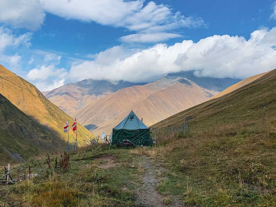 juta to roshka trek, Caucasus Mountains, roshka valley, stones, boulders, clouds, sky, kazbegi treks, Georgia flags, check point sadzele pass