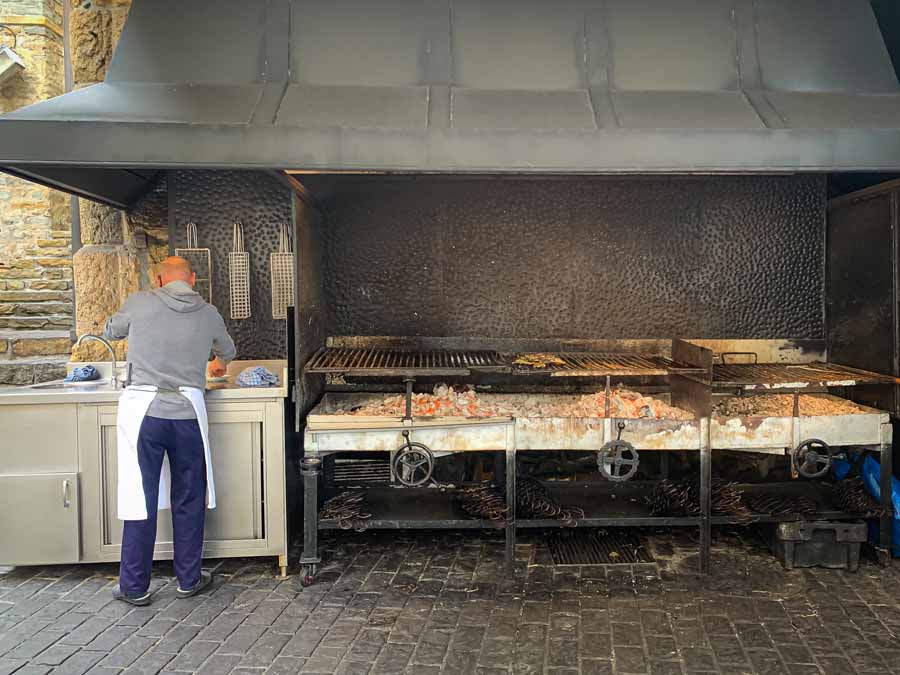 a man prepares the famous outdoor grills for the lunch time rush in Getaria