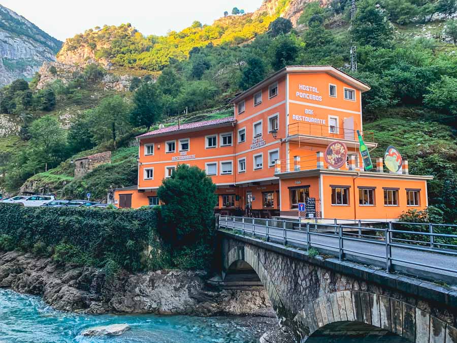 the bright orange Poncebos Hostal sits along the Cares River in the Picos de Europa National Park