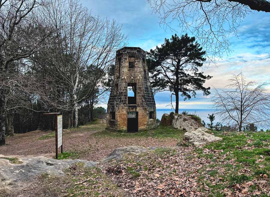 an abandoned old mill structure sits near the top of Monte Ulia